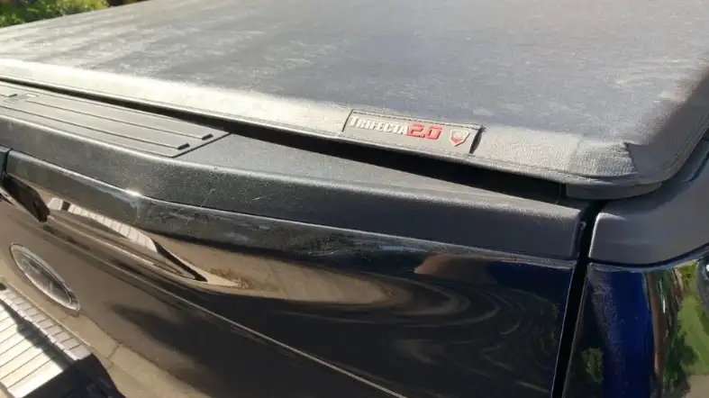 What are the risks while securing an open tonneau cover